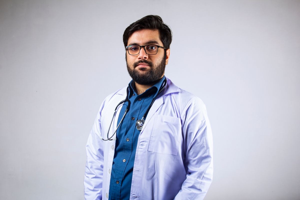 Portrait photo of a male veterinarian in a white coat